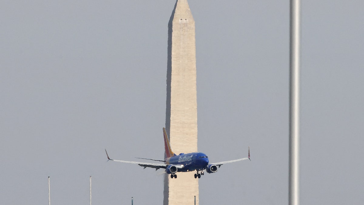 Plane near Reagan Airport, Washington Monument behind it