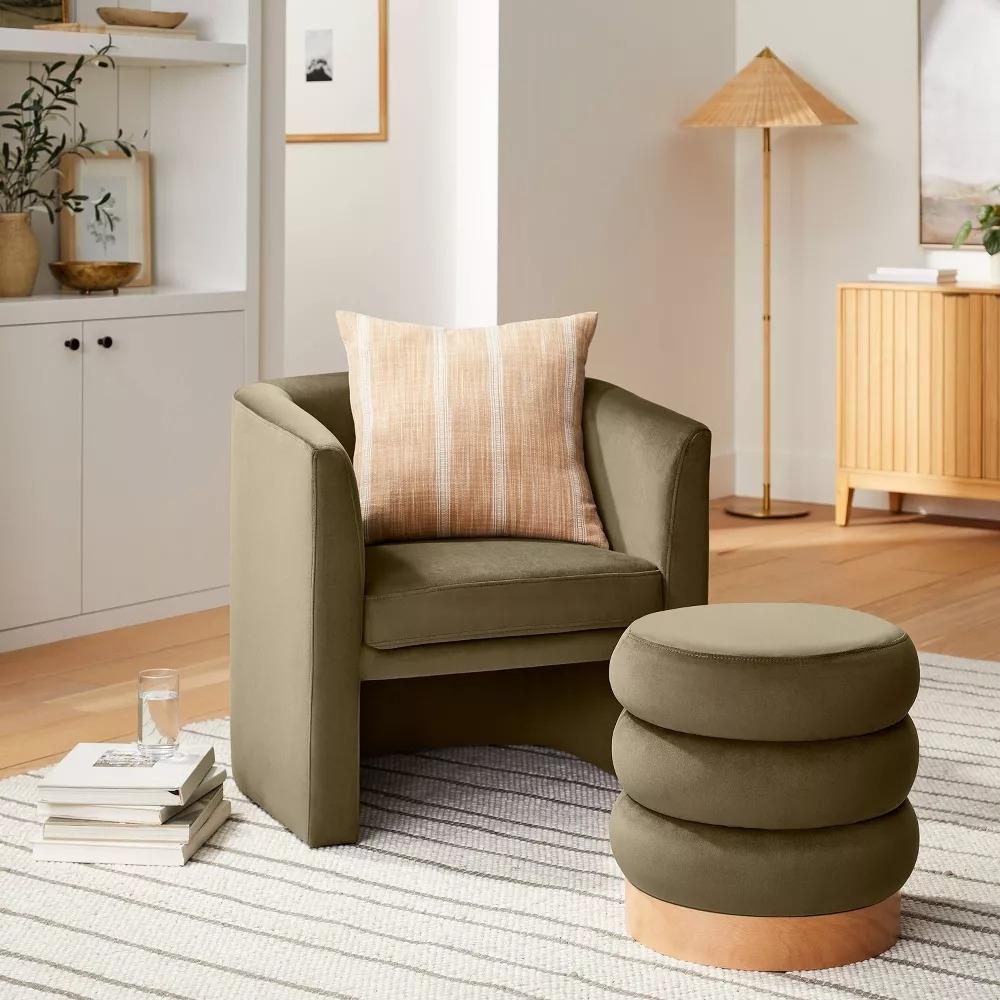 Modern living room with an olive green chair and matching ottoman.