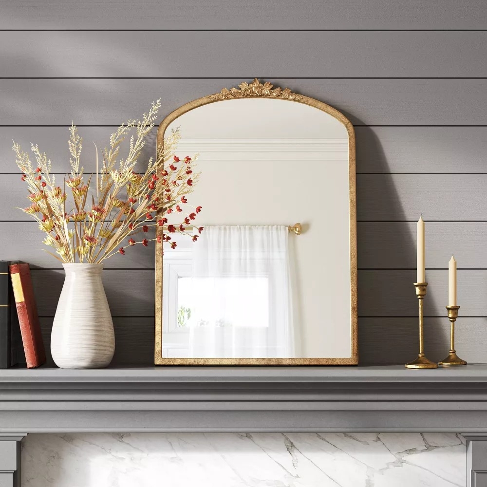 Arched mirror with a golden frame.