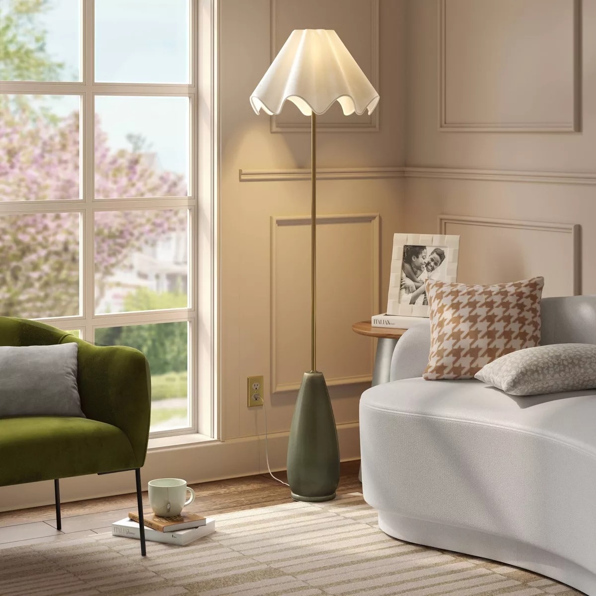 A fluted floor lamp with a green base and a wavy white lampshade.