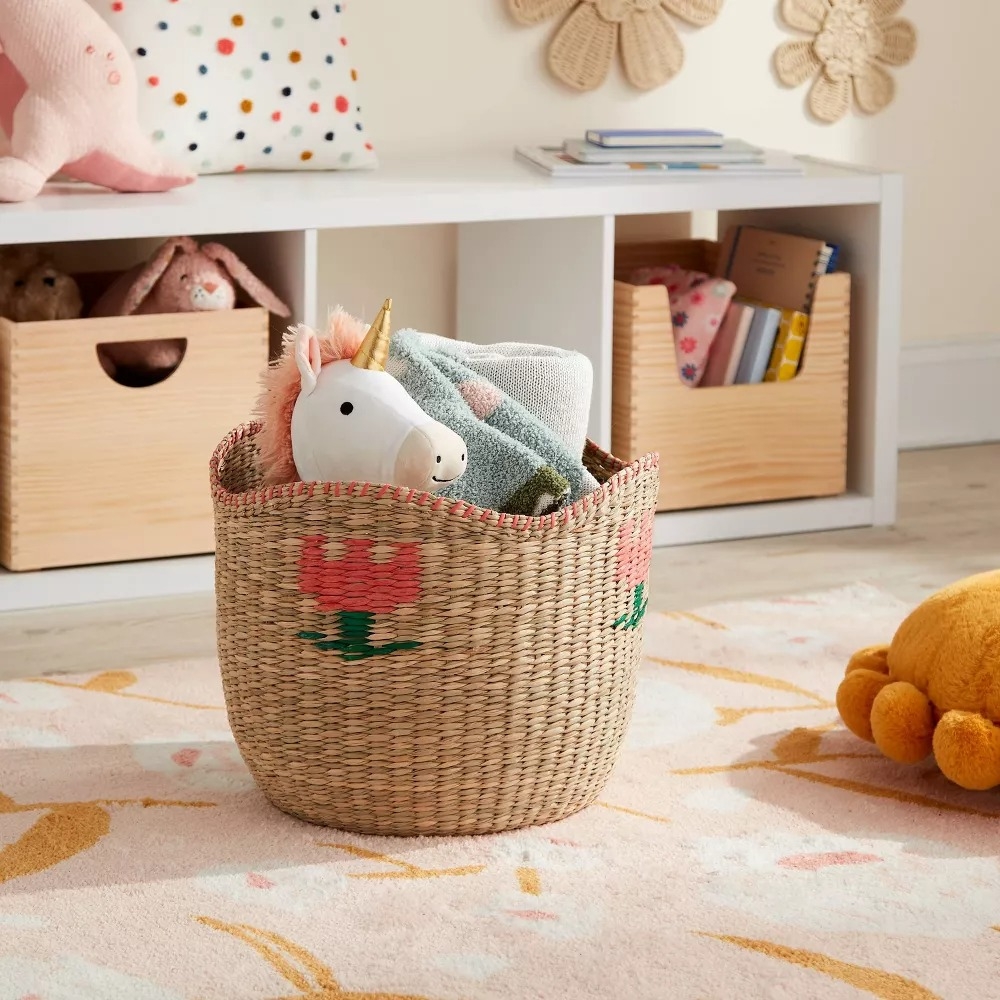 Woven basket with toy unicorn and blanket, in a cozy nursery setting with cubbies for organization